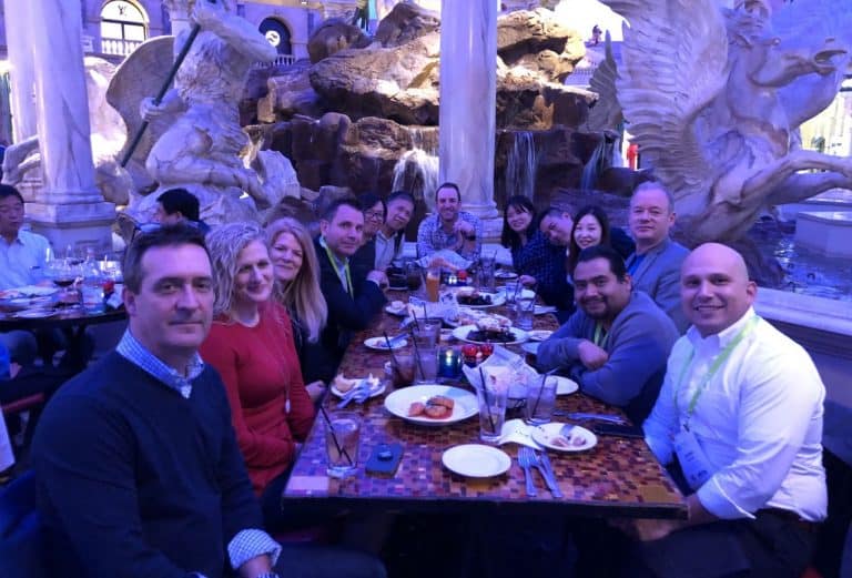 Group of people dining outdoors at CES 2018 Venetian suite.
