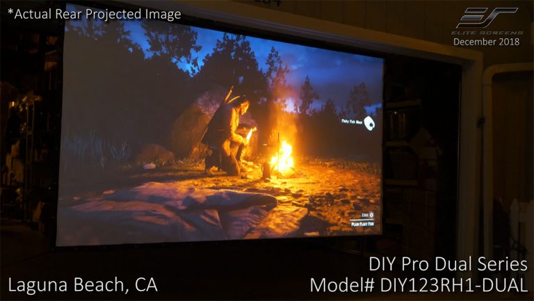 Outdoor projection screen displaying a movie scene with campfire at Laguna Beach, CA.