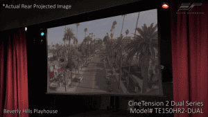 Projection screen displaying an outdoor scene with palm trees and a street, used for cinematic prese.