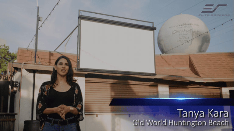 Outdoor motorized projection screen installed for outdoor movie viewing.