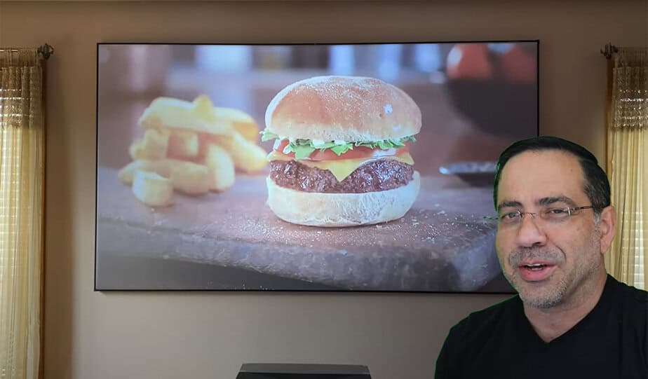 Projection screen displaying a burger and fries in a living room setting.