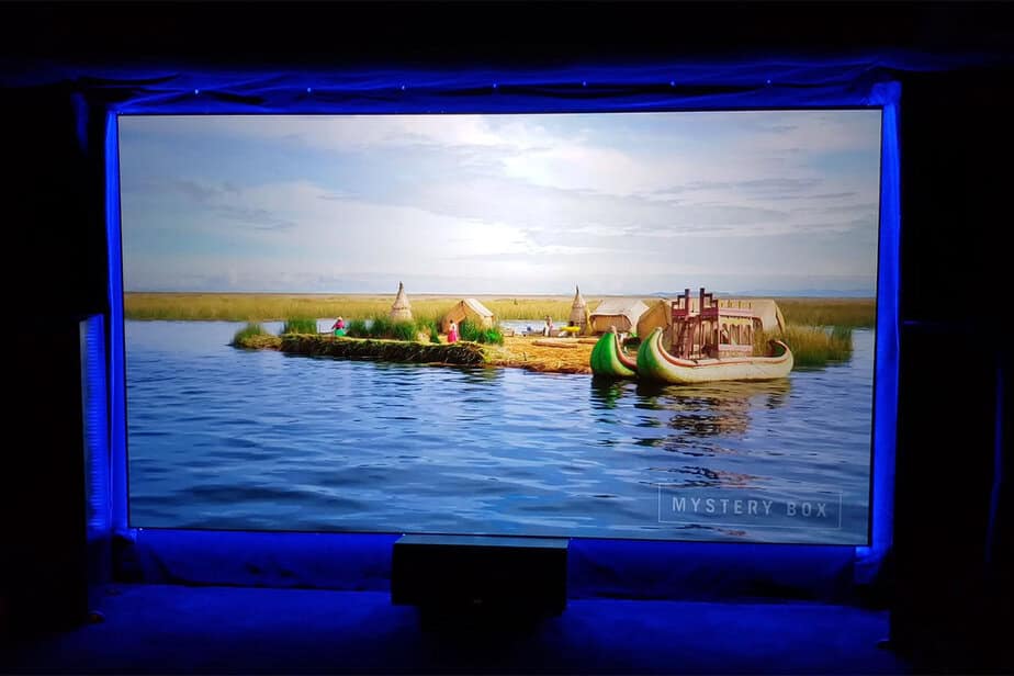 Projection screen displaying a scenic water landscape with a small island and boat.