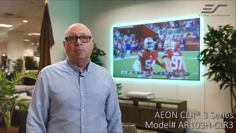 Quality projection screen in a modern setting with a man in front of a large screen.