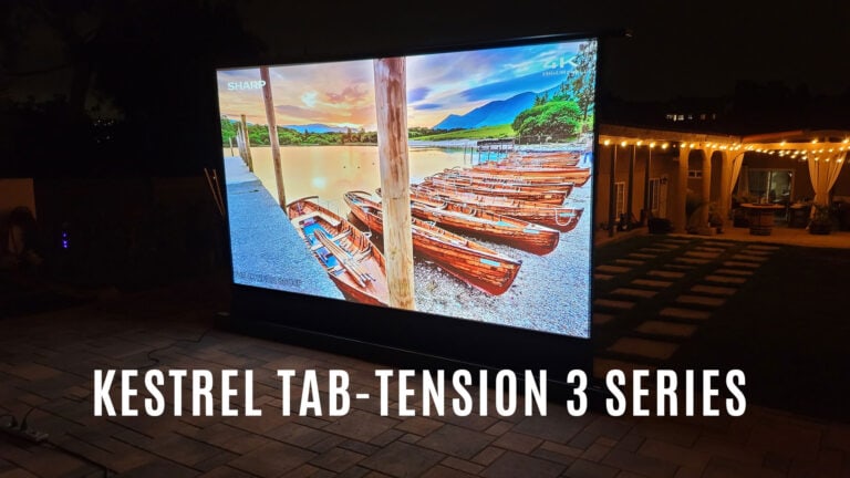 Outdoor projection screen displaying a scenic lake view at night.