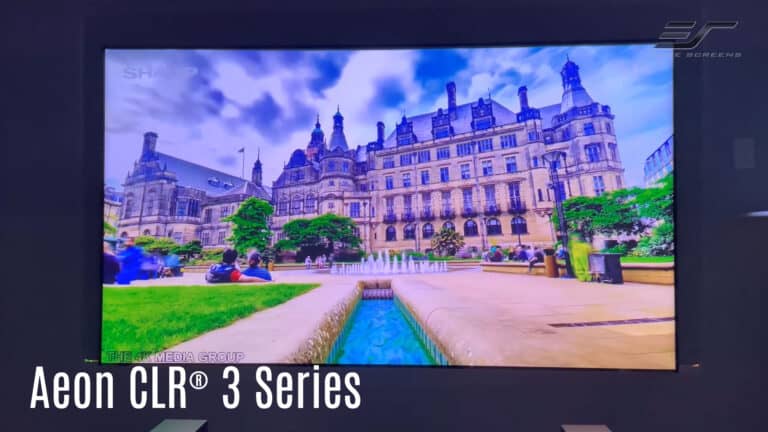 Large projection screen displaying a historic palace with lush gardens, ideal for home theater or pr.