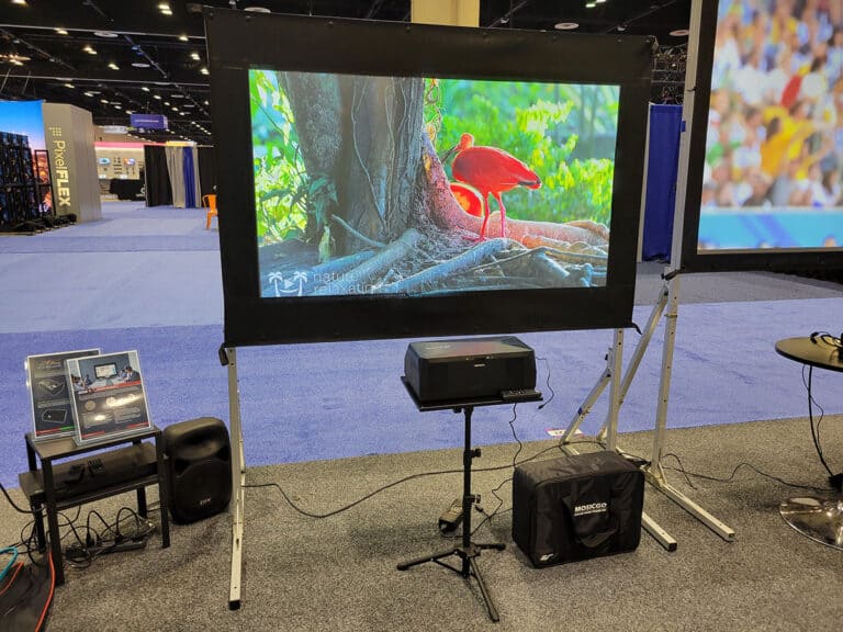 Projection screen with vibrant nature scene displayed, ideal for home theater or business presentati.