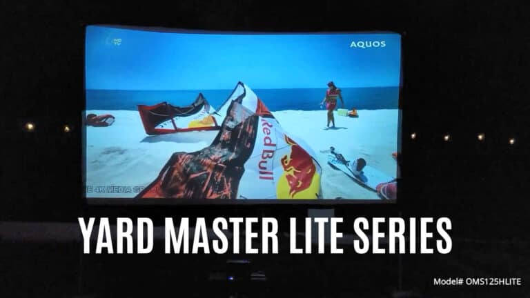 Projection screen displaying outdoor scene with kayaks and a person on the beach.