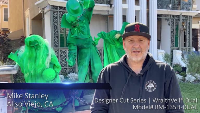 Street performer dressed in vibrant green costumes performing outdoors.