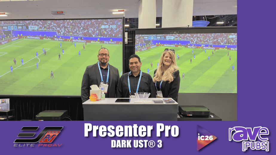 Three presenters standing in front of large projection screens at a tech event.