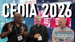 Three men at CEDIA 2026 discussing projection screens and AV technology.