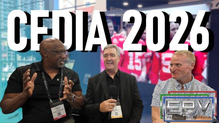 Three men at CEDIA 2026 discussing projection screens and AV technology.